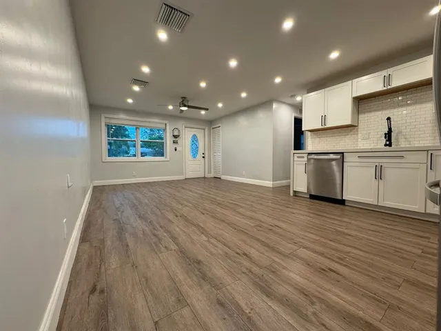 a view of a kitchen with sink and stainless steel appliances