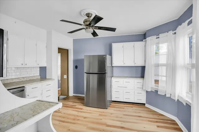 a kitchen with a refrigerator and a sink