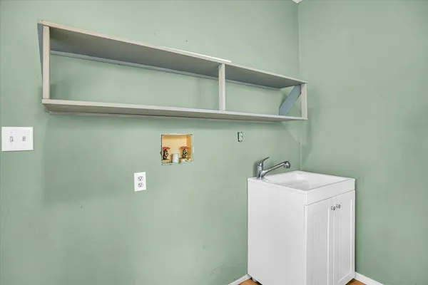 a utility room with a sink a washer and dryer