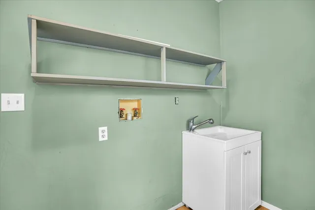 a utility room with a sink a washer and dryer