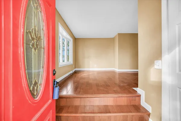 a view of a room with window and a rug