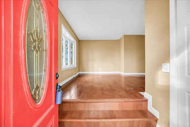 a view of a room with window and a rug