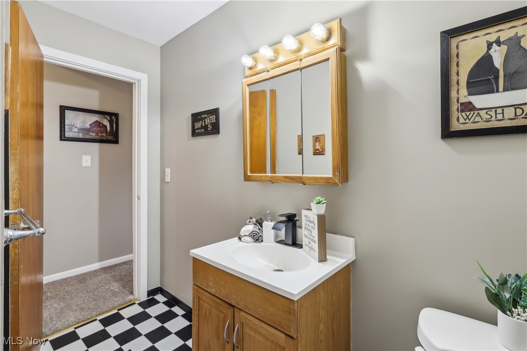 6623 Center Road Ashtabula, OH 44004 - Photo 32 of 49 Half bath with toilet, vanity, tile patterned floors, and baseboards