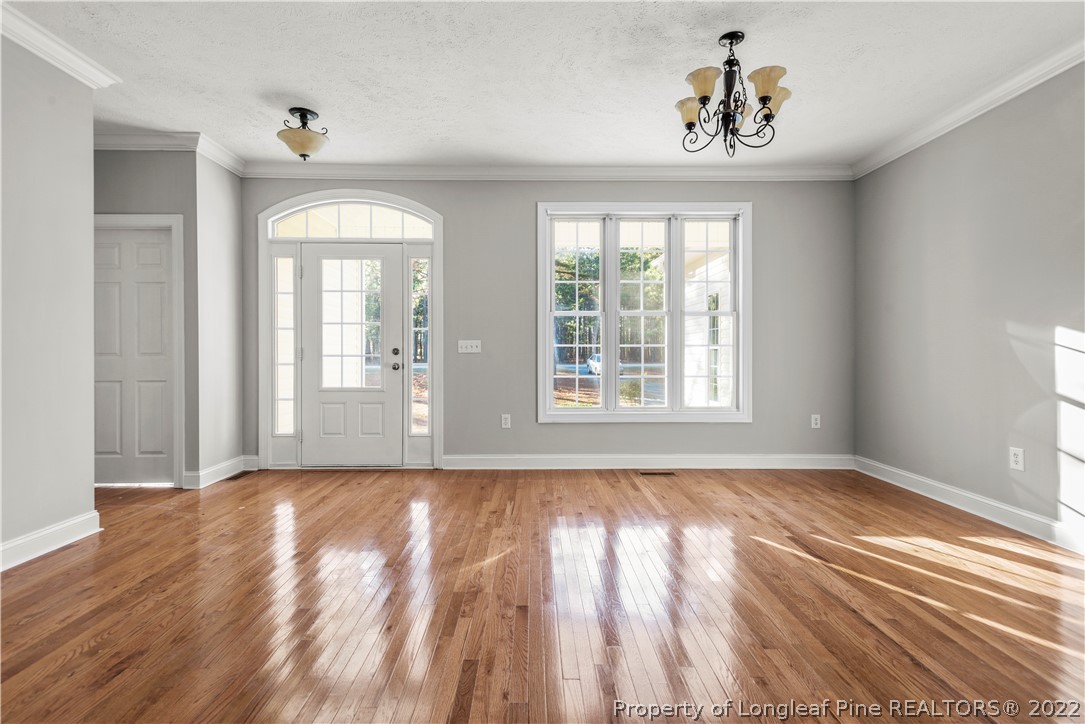9078 Calloway Road Aberdeen, NC 28315 - Photo 6 of 27 wooden floor in an empty room with a window
