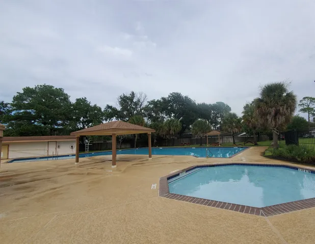a view of a swimming pool with an outdoor seating