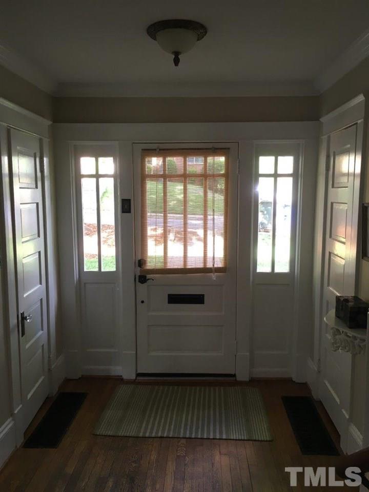 1425 Scales Street Raleigh, NC 27608 - Photo 2 of 25 a view of an empty room with a fireplace and a window