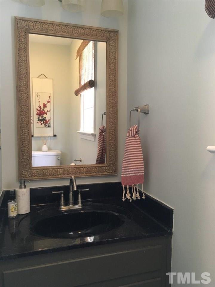 1425 Scales Street Raleigh, NC 27608 - Photo 11 of 25 a bathroom with a sink and a mirror