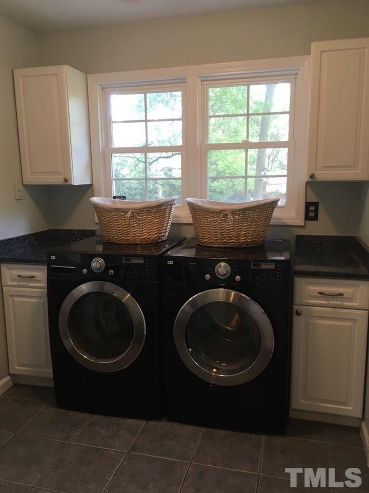 1425 Scales Street Raleigh, NC 27608 - Photo 12 of 25 a kitchen with a sink a stove and cabinets