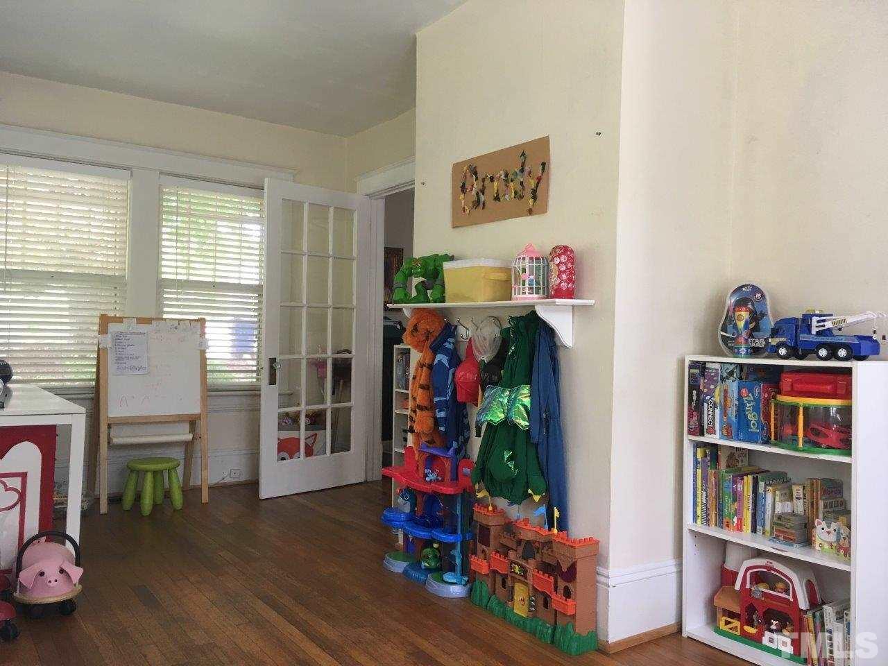 1425 Scales Street Raleigh, NC 27608 - Photo 14 of 25 a room with lots of books and a book shelf