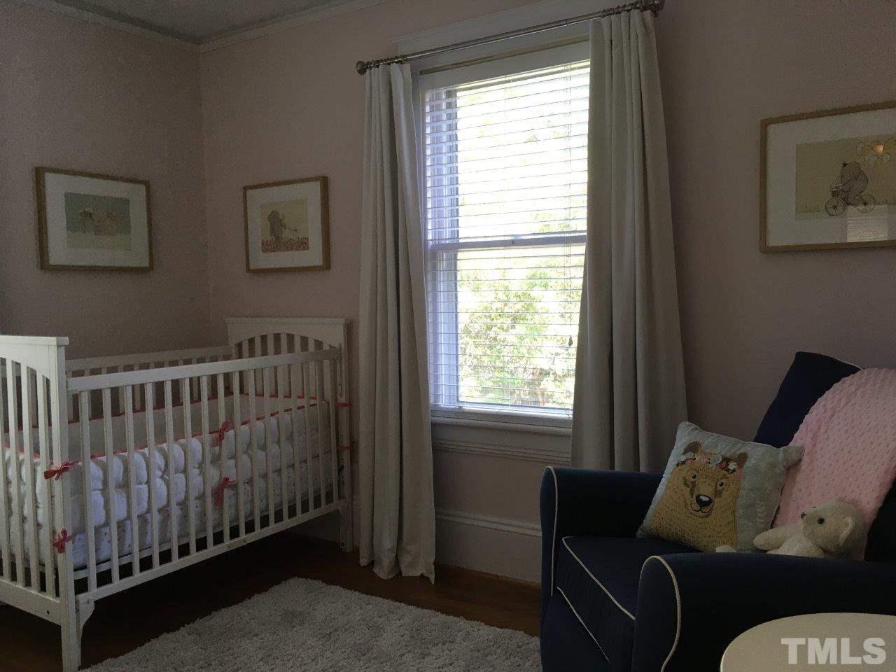 1425 Scales Street Raleigh, NC 27608 - Photo 17 of 25 a bedroom with furniture and a window