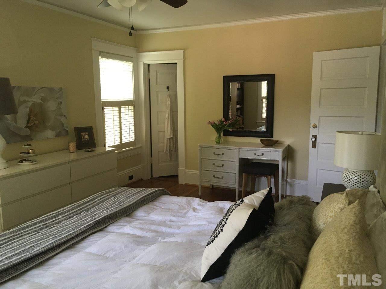 1425 Scales Street Raleigh, NC 27608 - Photo 19 of 25 a bed room with a bed and a television