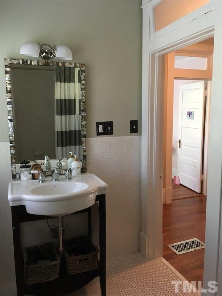 1425 Scales Street Raleigh, NC 27608 - Photo 20 of 25 a bathroom with a sink and a mirror