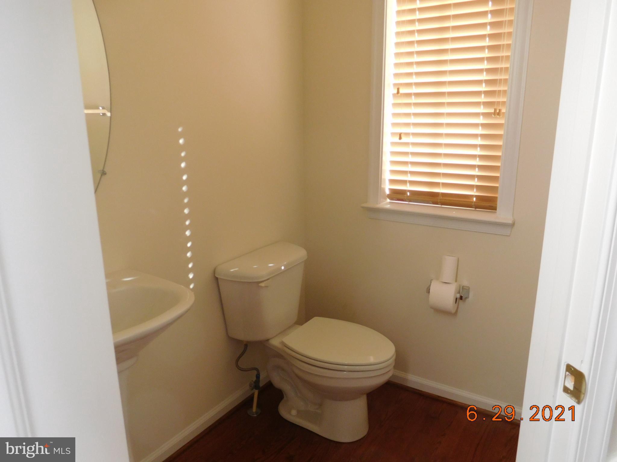 8246 Academy Road Ellicott City, MD 21043 - Photo 3 of 22 Half bath off of the foyer