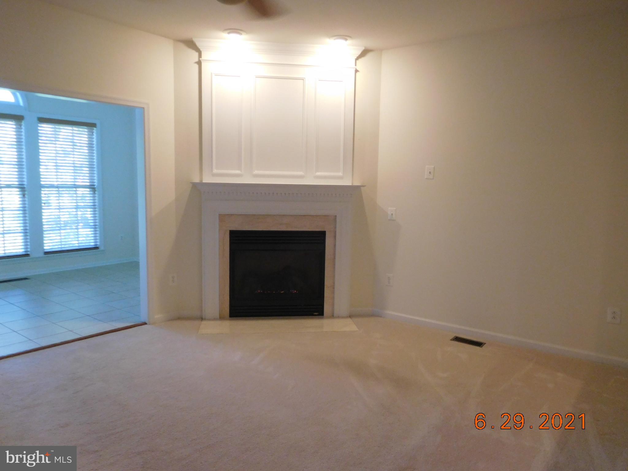 8246 Academy Road Ellicott City, MD 21043 - Photo 8 of 22 Living room with gas fireplace adjoins sunroom