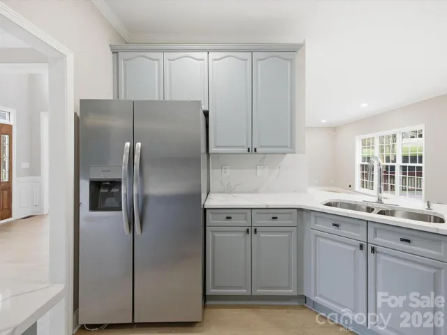a kitchen with a refrigerator sink and cabinets