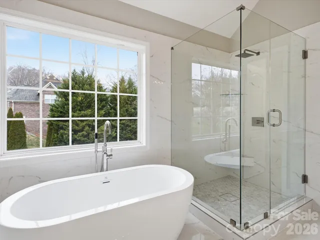 a bathroom with a tub and window