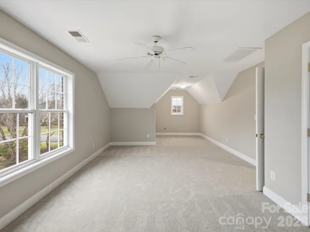 an empty room with a empty space and windows