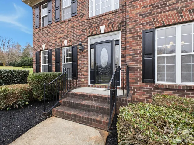 a view of a brick house with a large windows