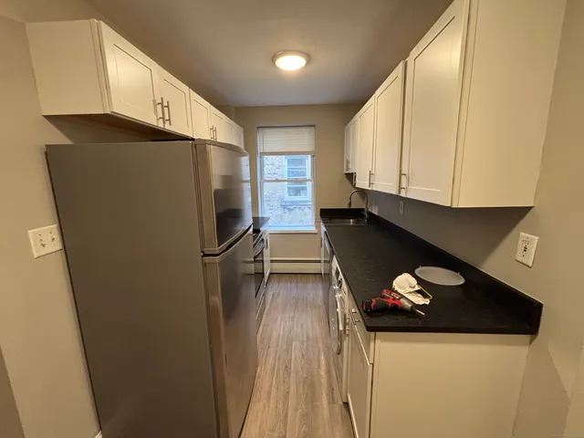 a kitchen with a refrigerator and a stove