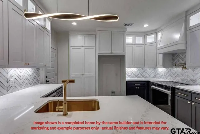 a kitchen with a sink a stove and cabinets