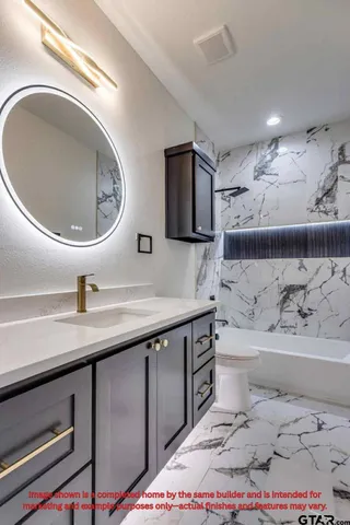 a bathroom with a toilet a sink and mirror