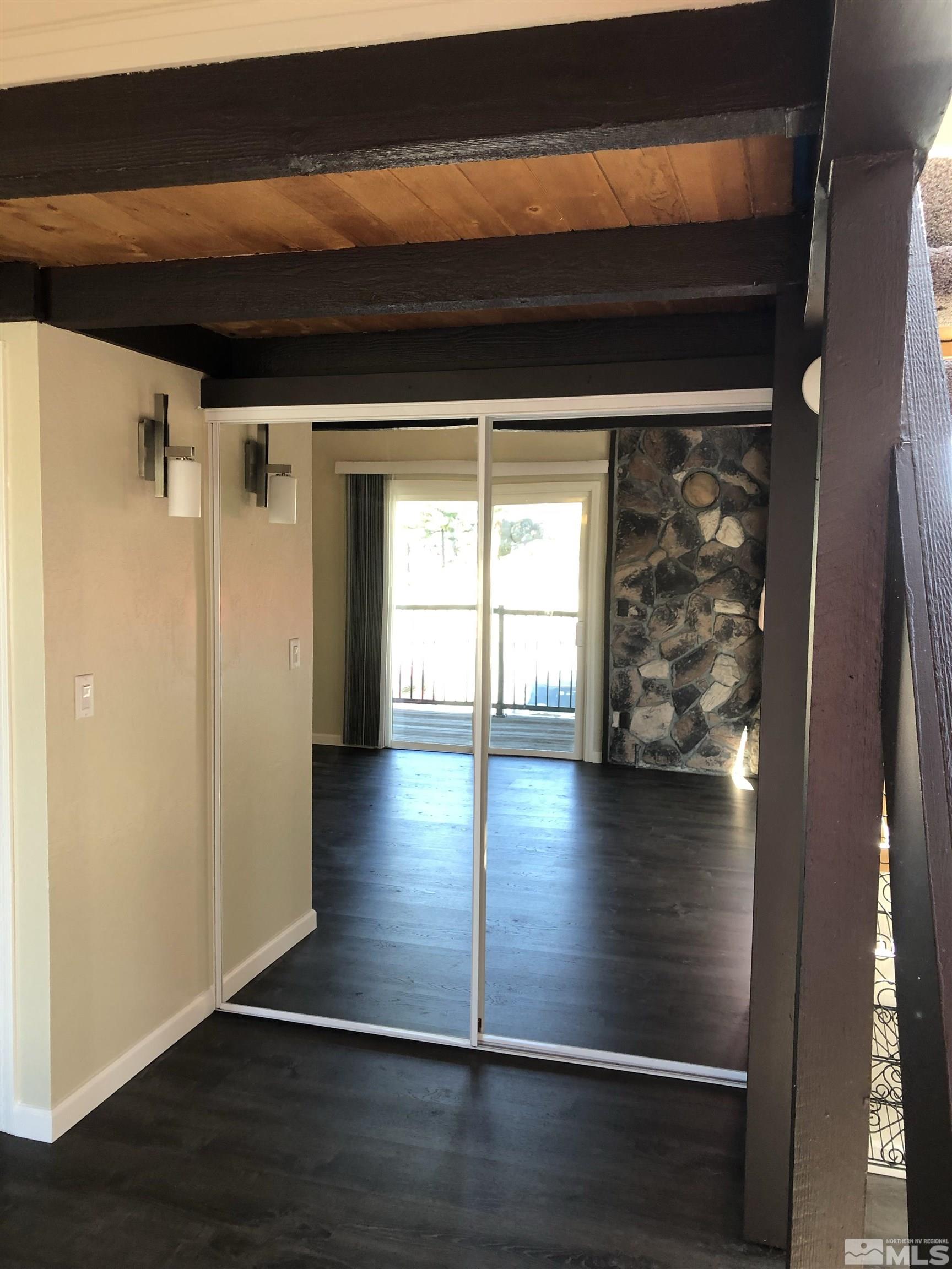 331 Tramway Drive, Unit 20 Stateline, NV 89449 - Photo 13 of 35 a view of a living room with hardwood floor and a large window