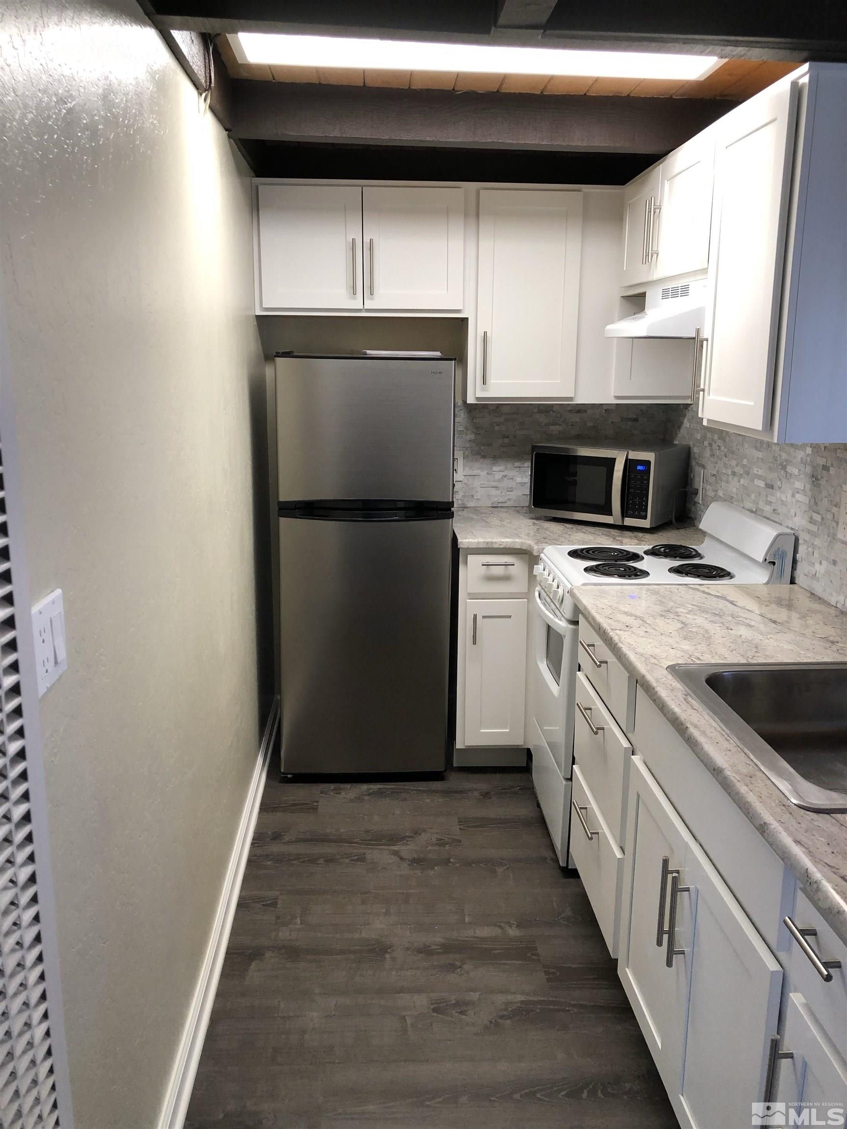 331 Tramway Drive, Unit 20 Stateline, NV 89449 - Photo 5 of 35 a kitchen with a refrigerator sink and stove