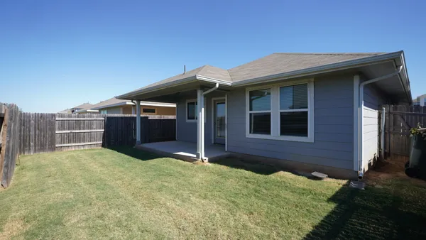 a view of house with backyard