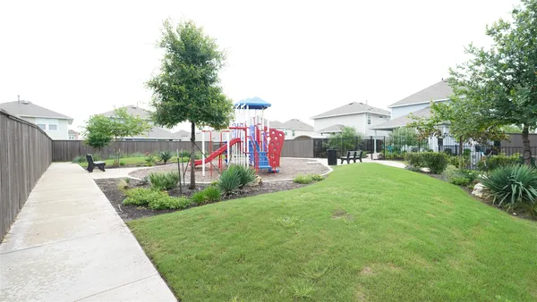a swimming pool with outdoor seating and garden