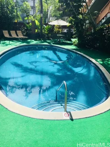 a view of a swimming pool with a yard