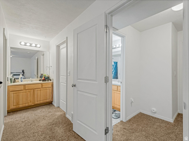 5038 West Red Shale Road Herriman, UT 84096 - Photo 13 of 16 Hallway with neutral tone carpeting and white baseboards