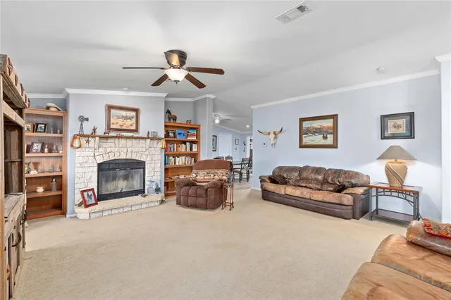 a living room with furniture a fireplace and a chandelier