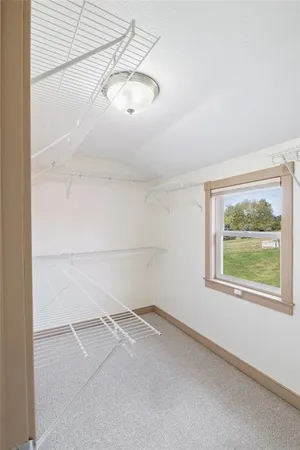 a spacious bathroom with a granite countertop toilet sink and mirror