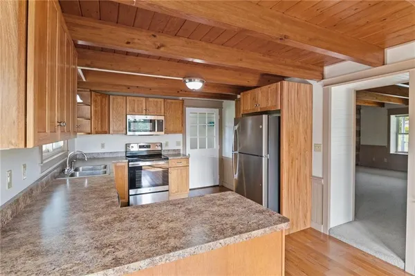 a kitchen with stainless steel appliances granite countertop a refrigerator stove and sink