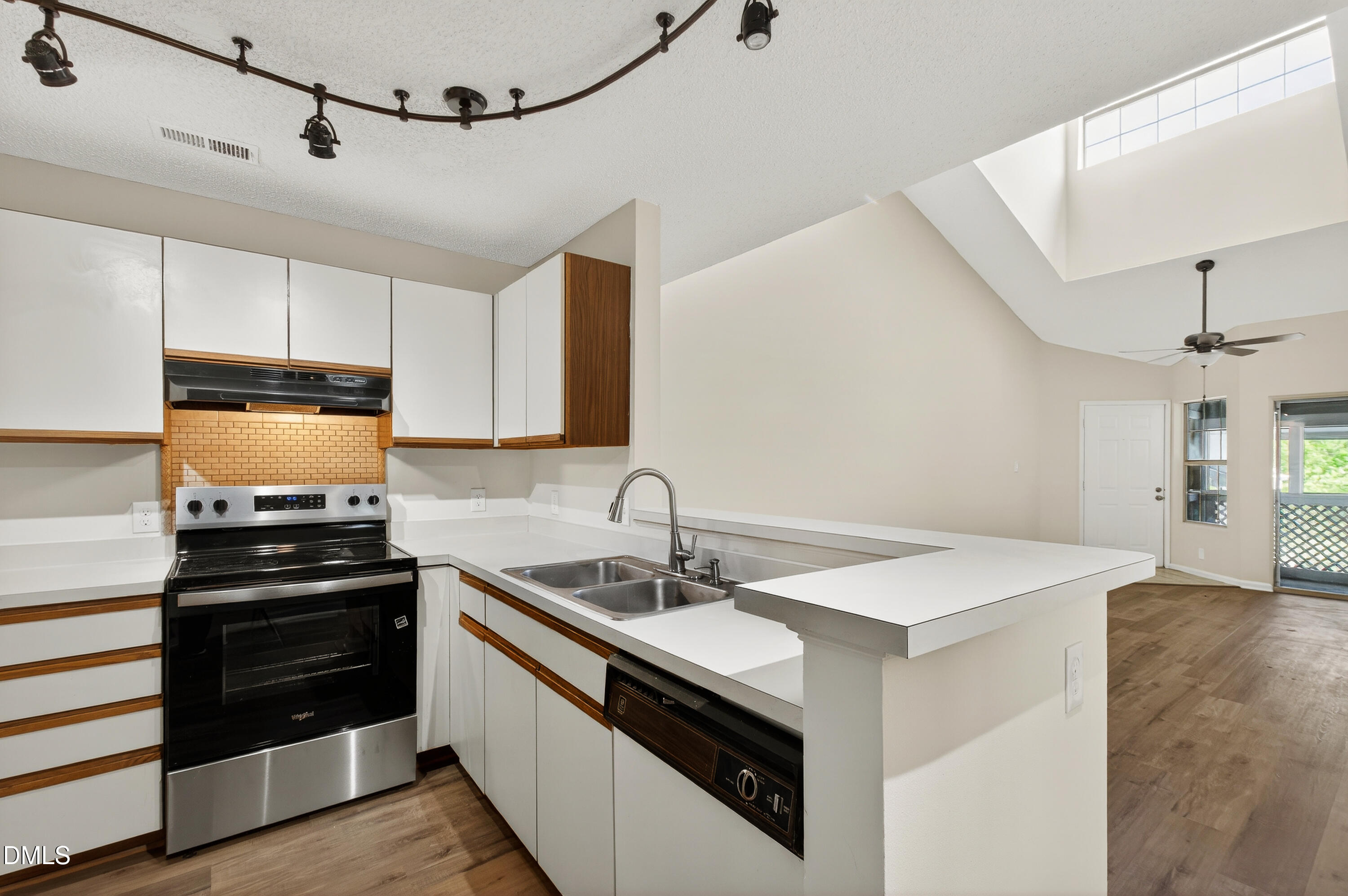 4921 Hollenden Drive, Unit 303 Raleigh, NC 27616 - Photo 12 of 33 a kitchen that has a sink and a stove