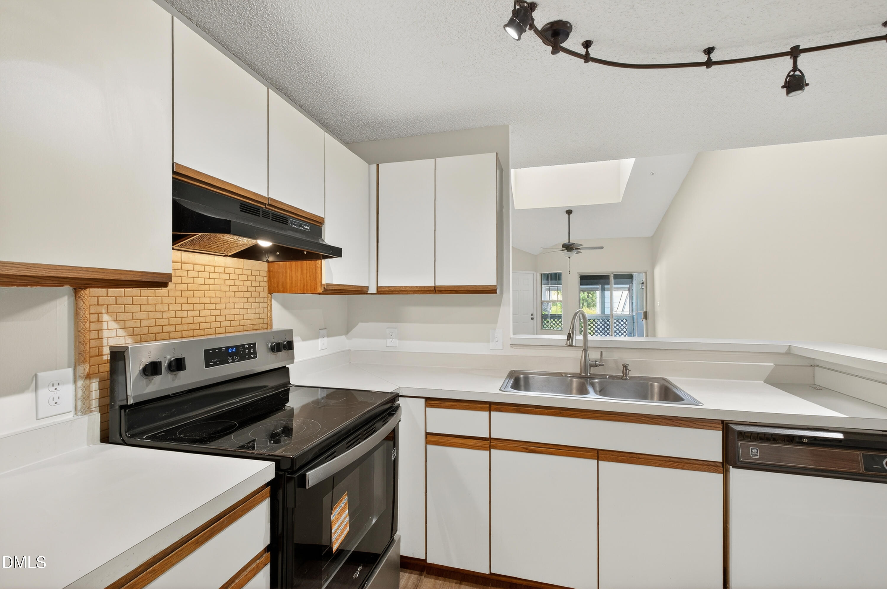 4921 Hollenden Drive, Unit 303 Raleigh, NC 27616 - Photo 14 of 33 a kitchen with a sink cabinets and stainless steel appliances
