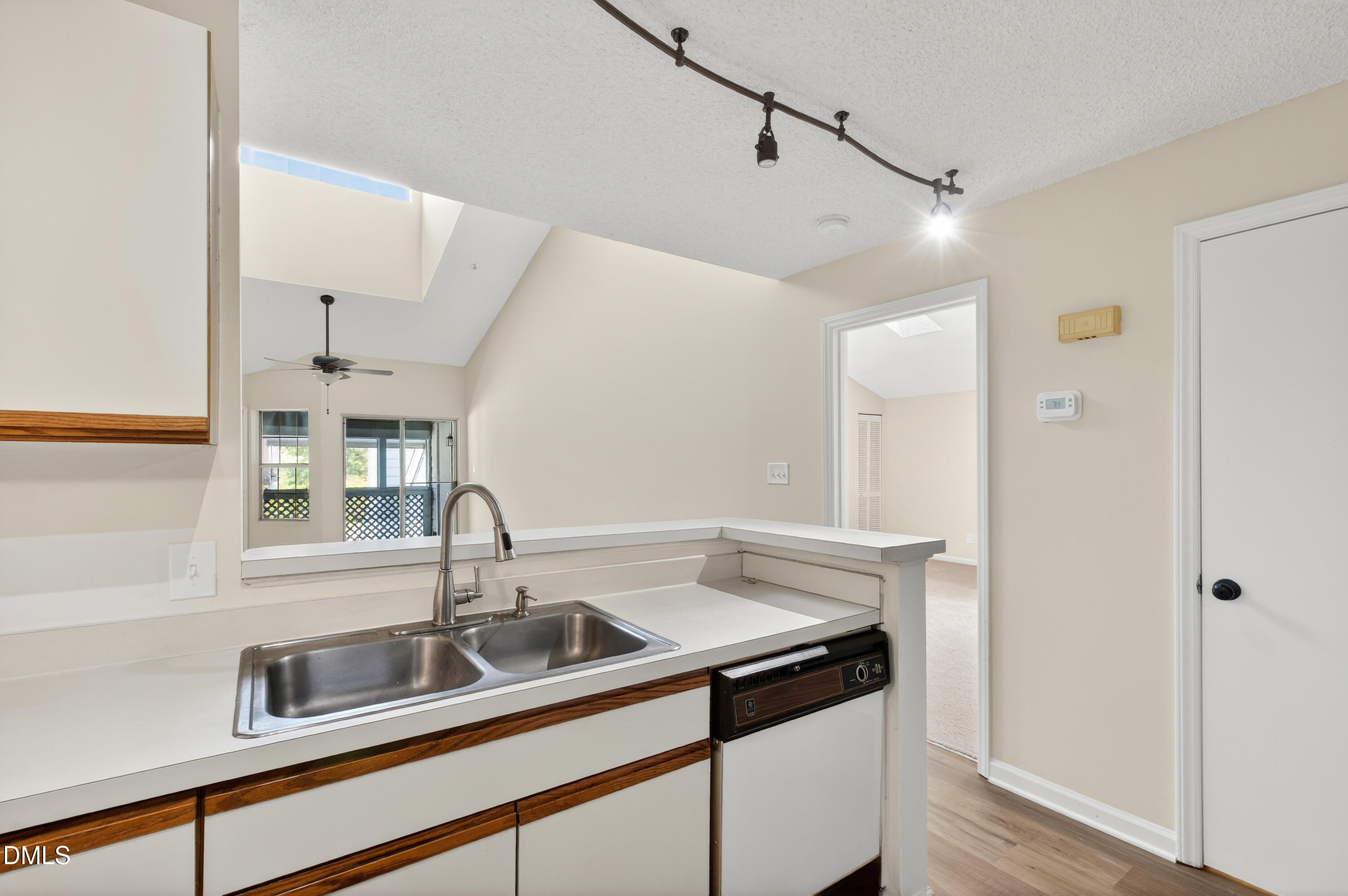 4921 Hollenden Drive, Unit 303 Raleigh, NC 27616 - Photo 15 of 33 a view of a sink a counter space and cabinets