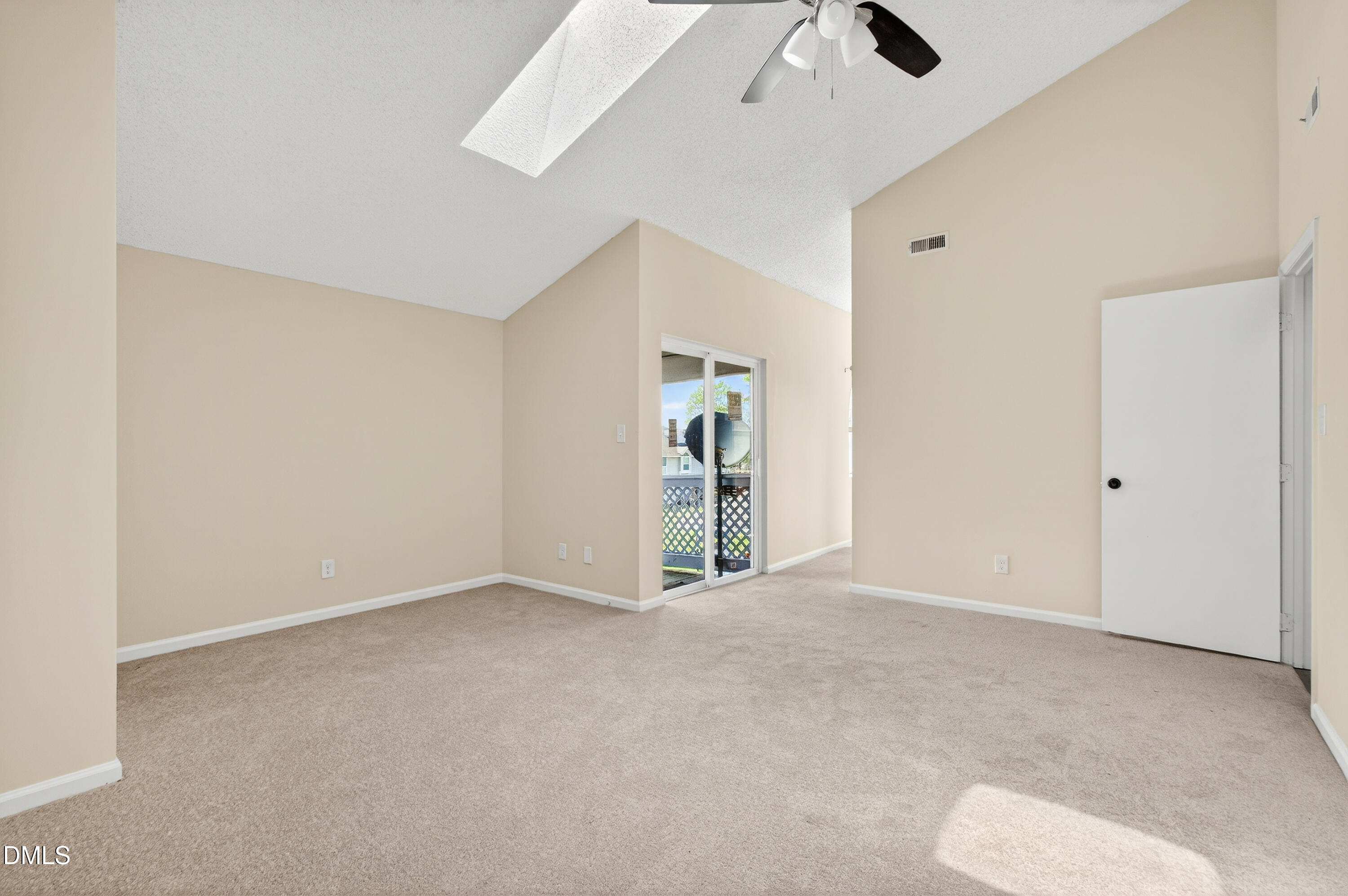 4921 Hollenden Drive, Unit 303 Raleigh, NC 27616 - Photo 17 of 33 an empty room with chandelier fan and windows