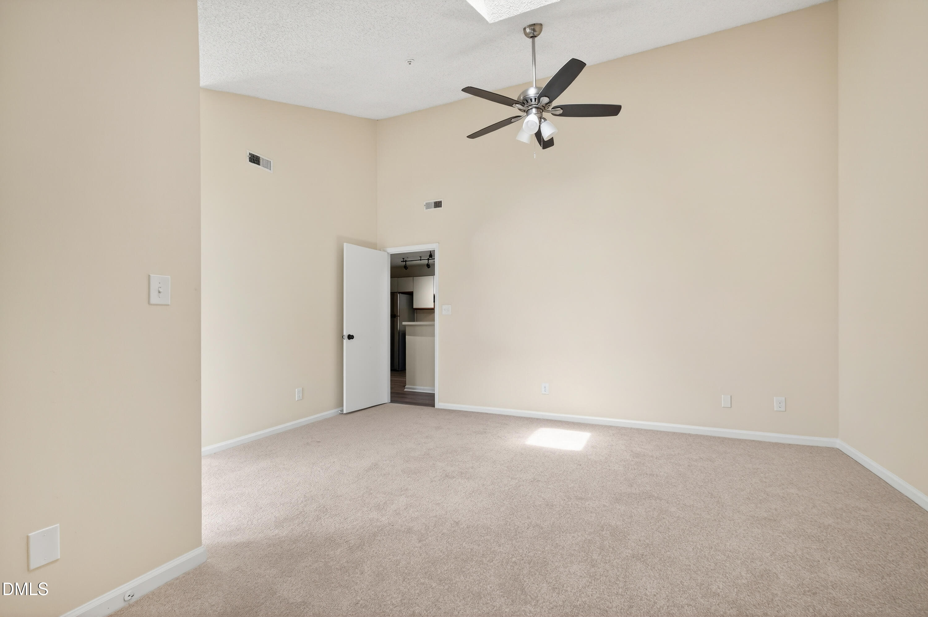 4921 Hollenden Drive, Unit 303 Raleigh, NC 27616 - Photo 18 of 33 an empty room with a ceiling fan and a window