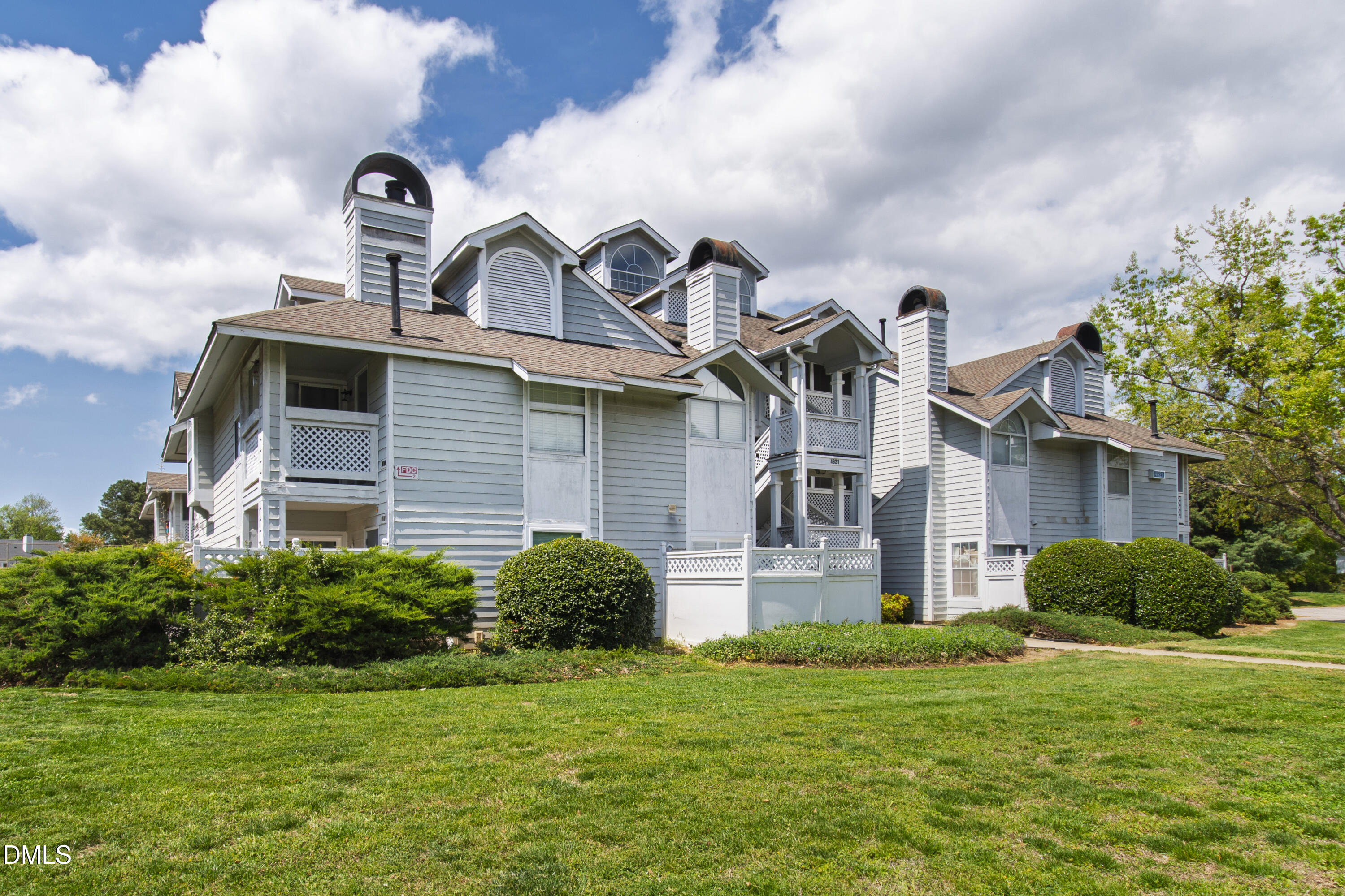 4921 Hollenden Drive, Unit 303 Raleigh, NC 27616 - Photo 2 of 33 a front view of a house with garden