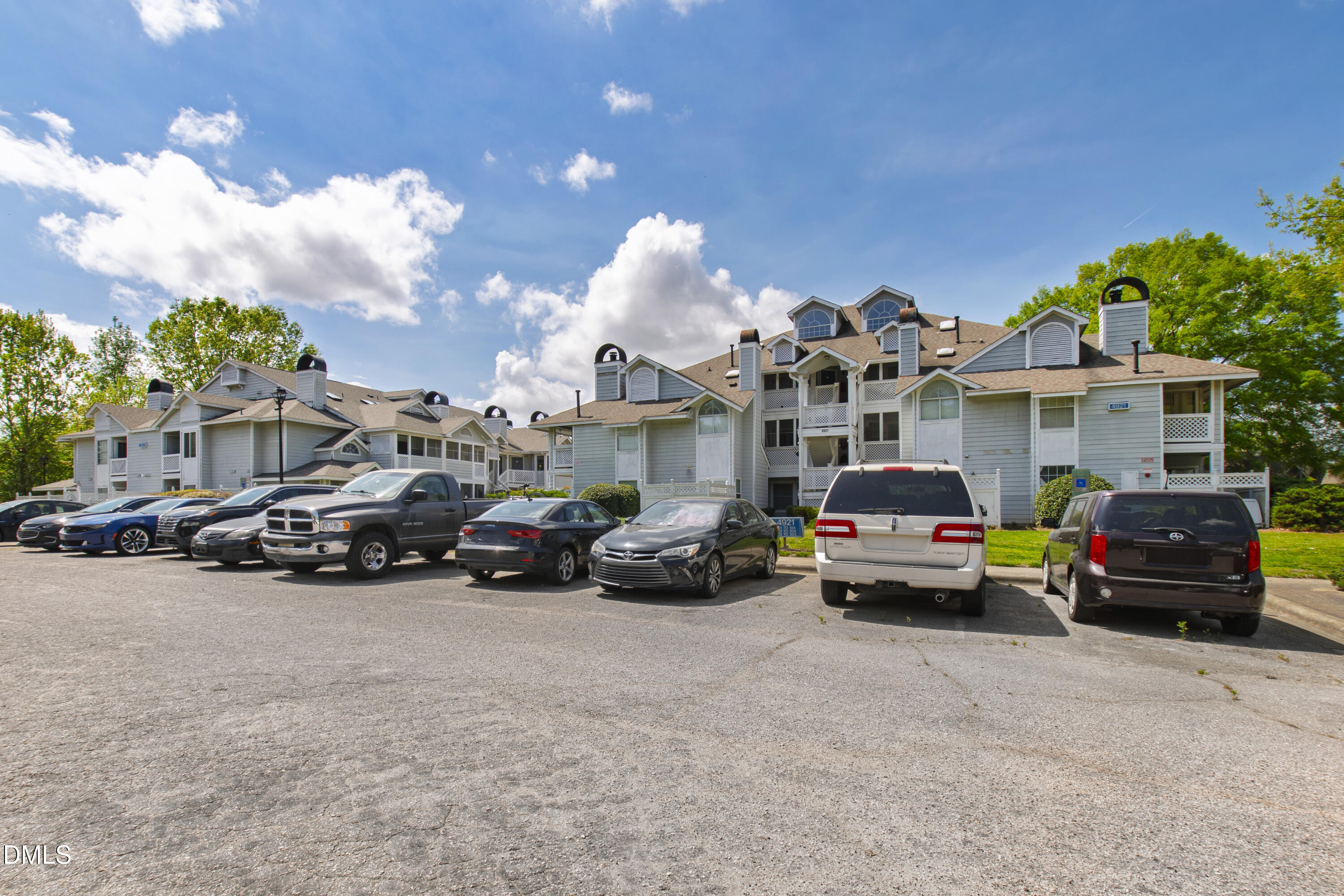 4921 Hollenden Drive, Unit 303 Raleigh, NC 27616 - Photo 33 of 33 a view of a cars parked in front of a house