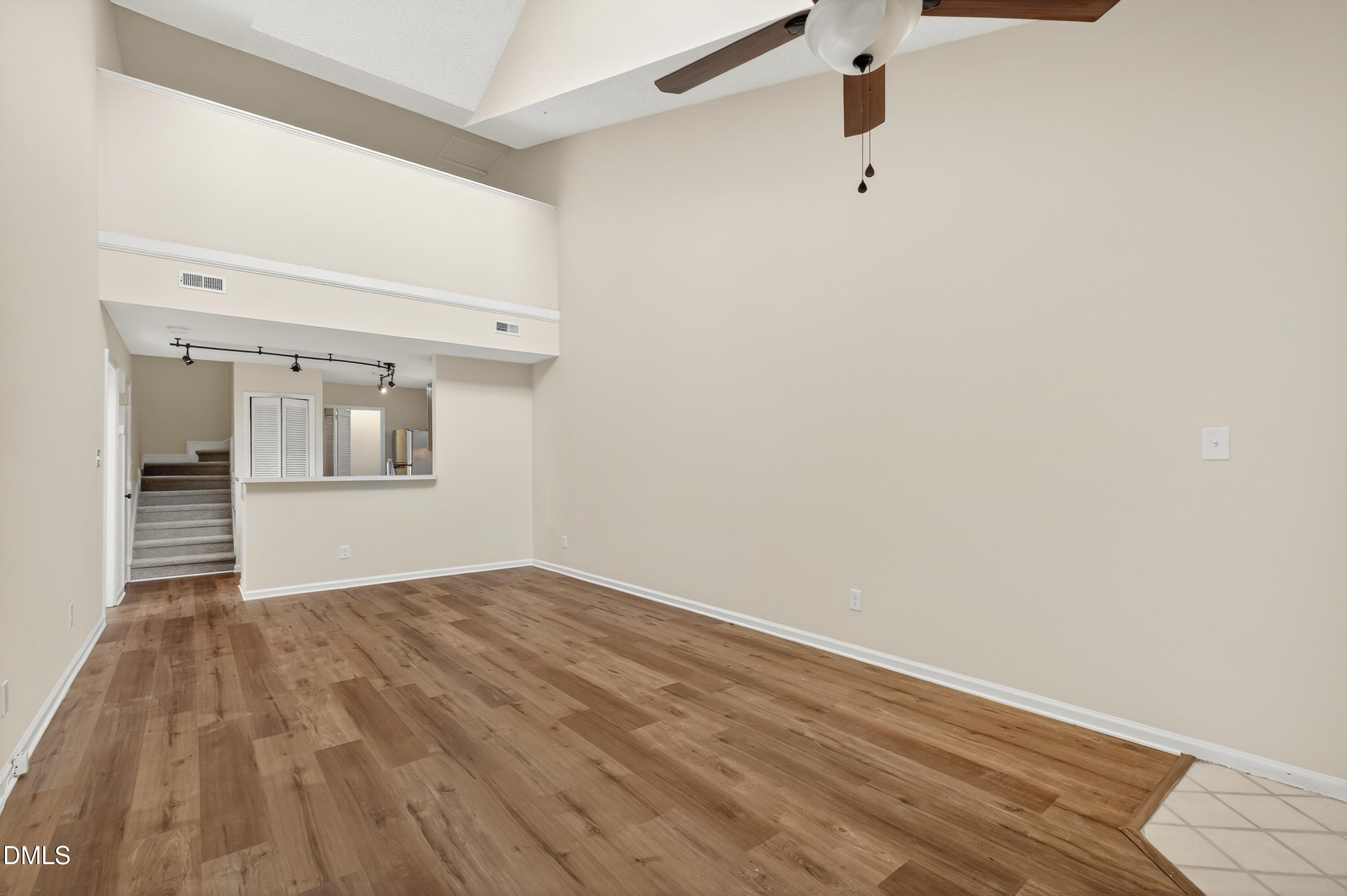 4921 Hollenden Drive, Unit 303 Raleigh, NC 27616 - Photo 6 of 33 a view of an empty room with wooden floor