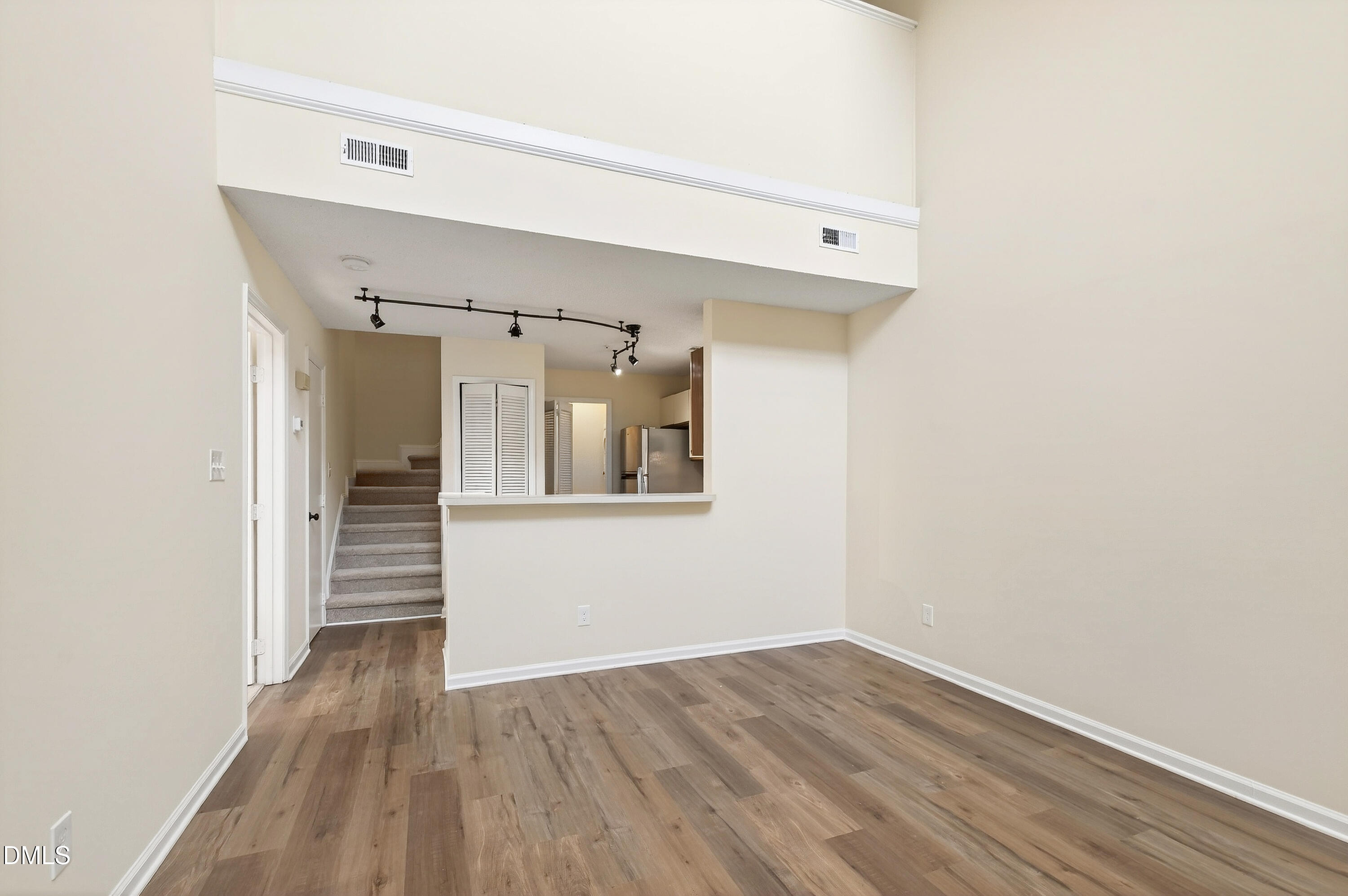 4921 Hollenden Drive, Unit 303 Raleigh, NC 27616 - Photo 7 of 33 a view of a hallway with wooden floor and closet