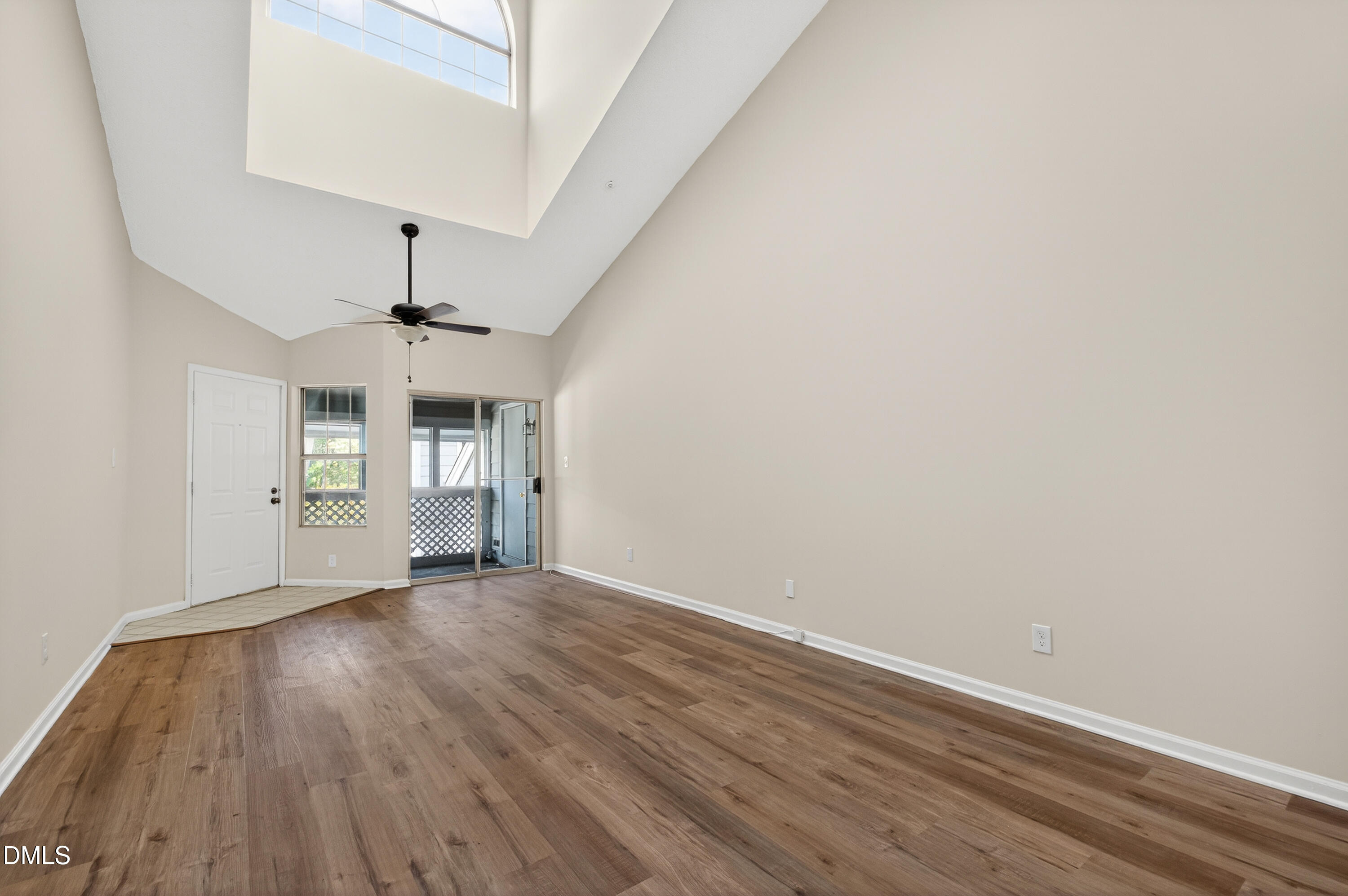 4921 Hollenden Drive, Unit 303 Raleigh, NC 27616 - Photo 9 of 33 wooden floor in an empty room with a window