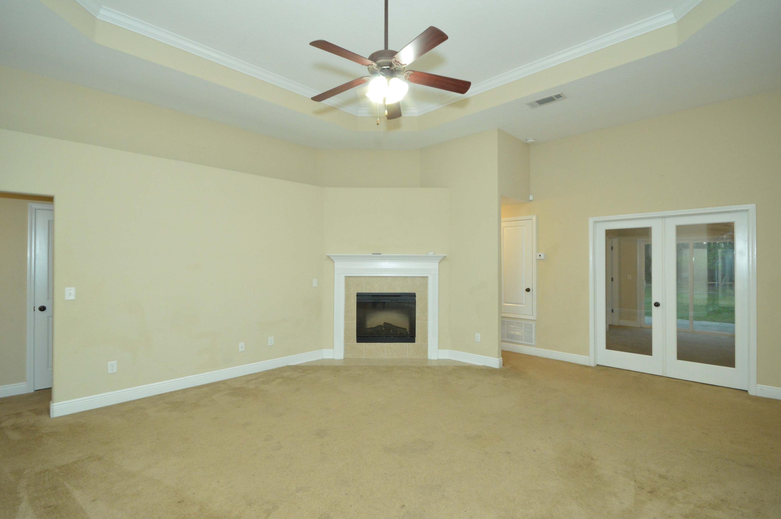 9970 Nichols Lake Road Milton, FL 32583 - Photo 11 of 48 a view of an empty room with a fireplace