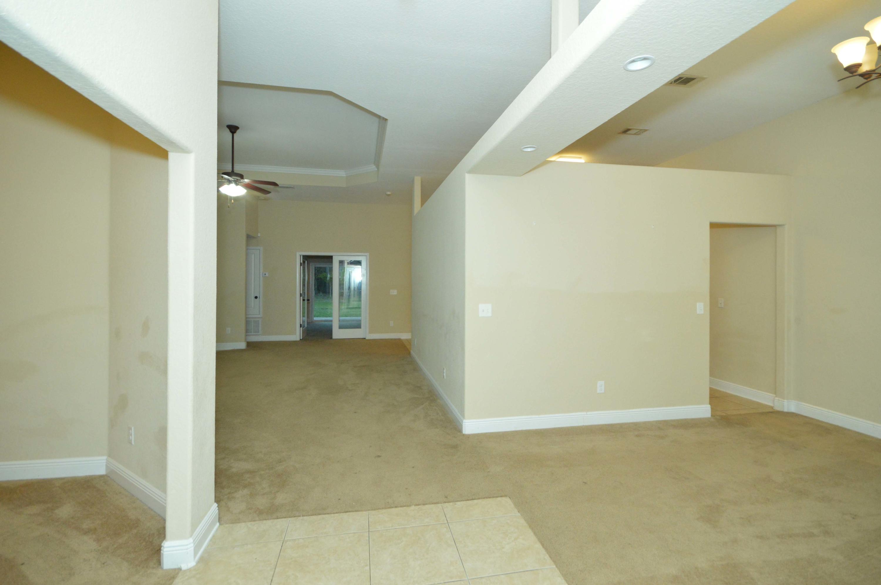 9970 Nichols Lake Road Milton, FL 32583 - Photo 12 of 48 a view of a hallway with wooden shelves