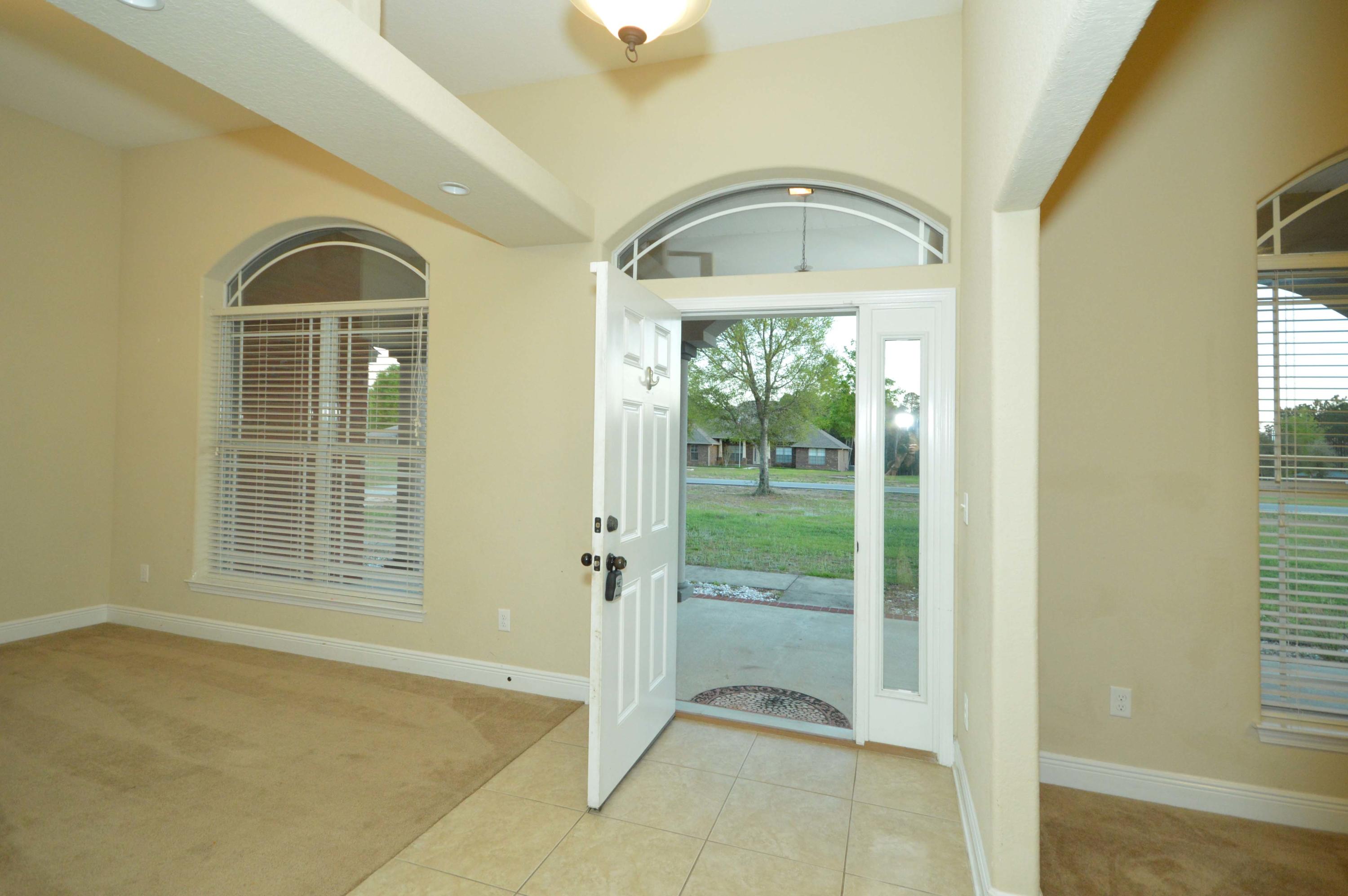 9970 Nichols Lake Road Milton, FL 32583 - Photo 15 of 48 a view of a livingroom with wooden floor and a fireplace