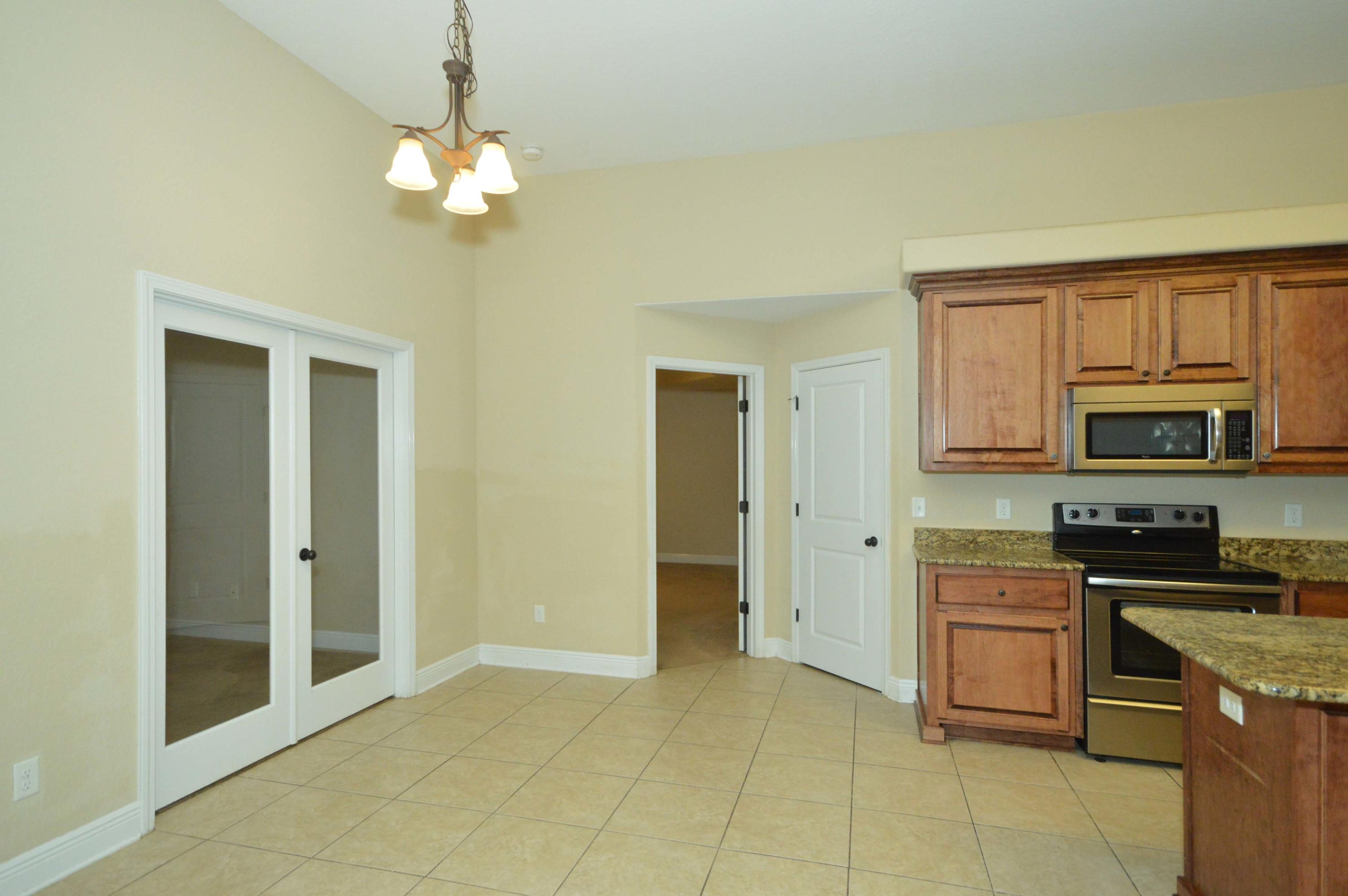 9970 Nichols Lake Road Milton, FL 32583 - Photo 19 of 48 a kitchen with stainless steel appliances granite countertop a stove and a sink