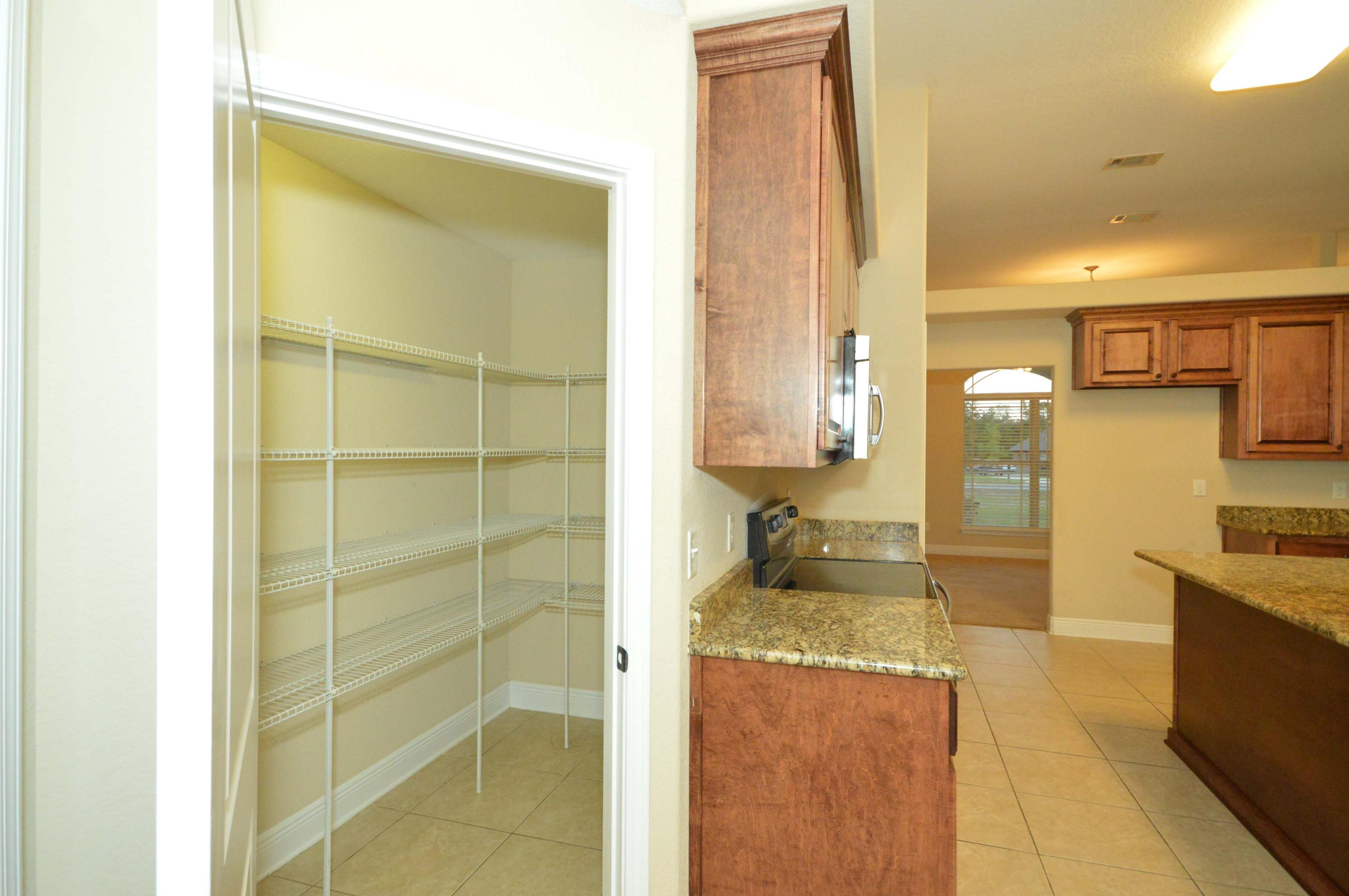 9970 Nichols Lake Road Milton, FL 32583 - Photo 21 of 48 a bathroom with a granite countertop sink and a mirror