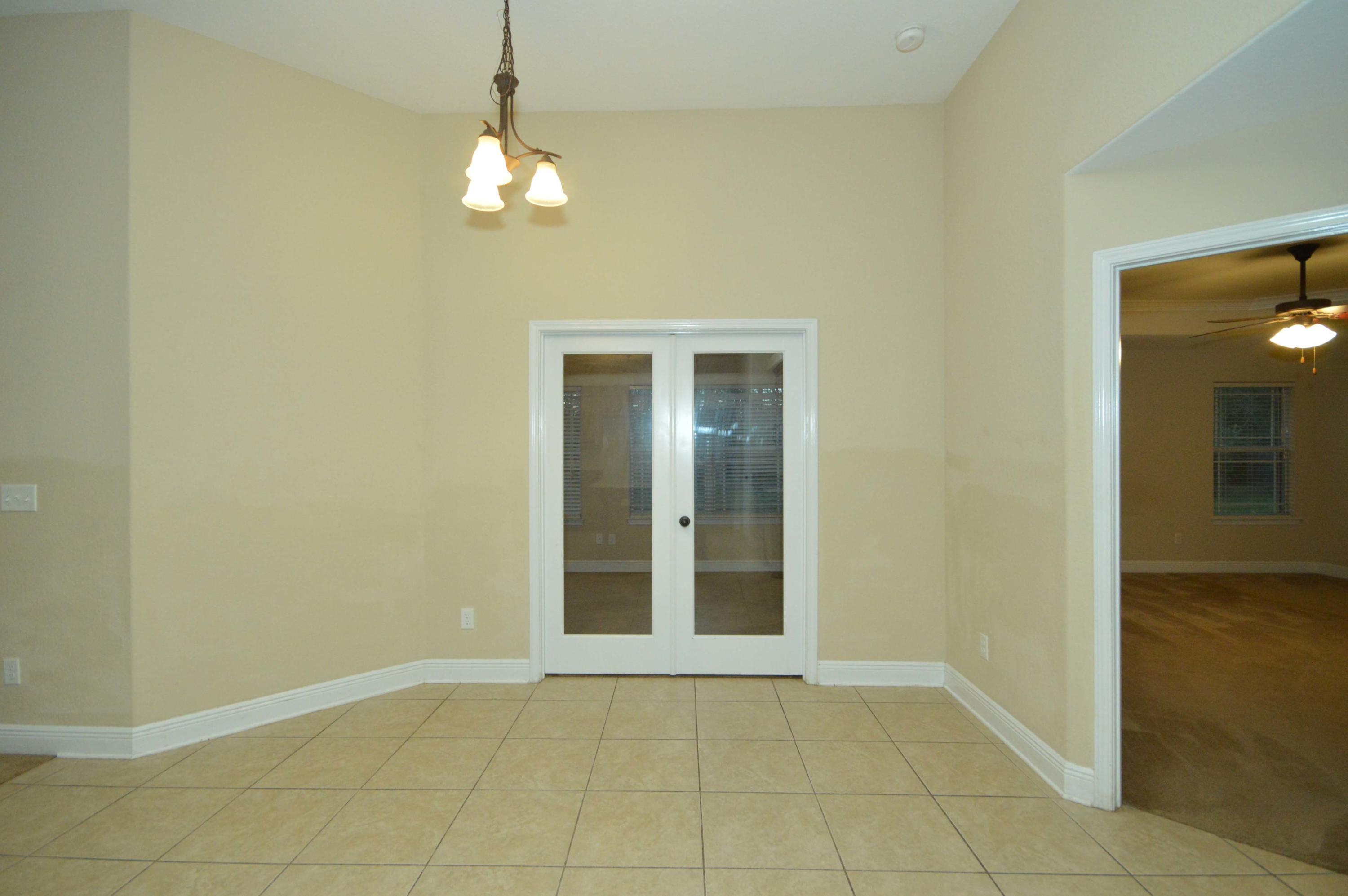 9970 Nichols Lake Road Milton, FL 32583 - Photo 25 of 48 a view of an empty room with window and wooden floor